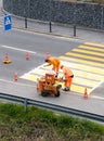 Maienfeld, GR / Switzerland - April 2, 2019: workers painting and marking a pedestrian crosswalk with fresh yellow paint to ensure Royalty Free Stock Photo