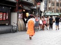 Maiko apprentice geisha or geiko performing artists walking on Hanamikoji Street of Gion old town with Japanese people and foreign Royalty Free Stock Photo