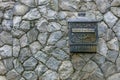 Mail box on a stone wall stone wall texture Royalty Free Stock Photo