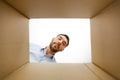 Man looking into open parcel box Royalty Free Stock Photo