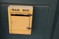 Mail post text sign on yellow old private mailbox of vintage house Royalty Free Stock Photo