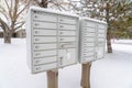 Mailbox against neighbourhood landscape covered with fresh white snow in winter