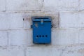 Mailbox blue in retro style on brick wall. old iron