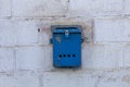 Mailbox blue in retro style on brick wall. old iron