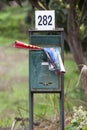 A mailbox with in the brochures of supermarkets. Blurred background.