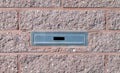 Mailbox built-in into pink brick wall