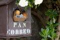 A mailbox with fresh bread and newspaper inside