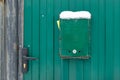 The mailbox is green next to the wicket house. Gates of the house with a lock Royalty Free Stock Photo