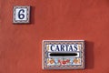 Cartas Mailbox and house number plate in Spain, colorful red white blue color design 6 six Royalty Free Stock Photo