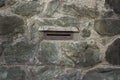 Mailbox opening on a stone wall