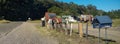 Mailbox, retro style, on country road. Rusty letterbox. Panoramic view.