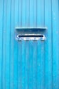Mailbox slot on industrial metallic wall