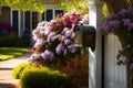 mailbox surrounded by blooming flowers, with view to the front door of a house