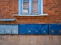 Mailboxes on a brick wall. On a wall a window and boxes for letters and newspapers Royalty Free Stock Photo