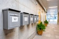Mailboxes hanging on concrete wall inside apartment building hallway Royalty Free Stock Photo