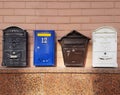 Mailboxes on the wall of a brick house