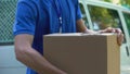 Mailman catching cardboard box and showing thumbs up, bad delivery service