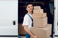 Mailman unloads the car with parcels, delivery