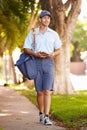 Mailman Walking Along Street Delivering Letters Royalty Free Stock Photo