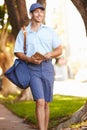 Mailman Walking Along Street Delivering Letters Royalty Free Stock Photo