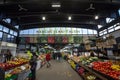 Main alley of Marche Jean Talon Market with merchants selling fruits, vegetables and groceries.