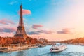 main attraction of Paris and all of Europe is the Eiffel tower in the rays of the setting sun on the bank of Seine river with