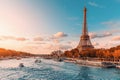 main attraction of Paris and all of Europe is the Eiffel tower in the rays of the setting sun on the bank of Seine river with