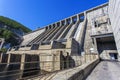 The main building with turbines of the Zeya hydroelectric station on the background of a concrete dam.