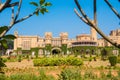 Main buildings of Bangalore Palace, With blurred tree branches in the foreground, Bangalore, Karnataka, India.