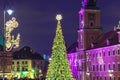 Main Christmas tree with glowing golden garlands on the town square of the old town against the backdrop of an old house with a Royalty Free Stock Photo