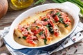 Main course baked chicken with sun-dried tomatoes and spinach in cheese sauce close-up in a pan on the table. Horizontal Royalty Free Stock Photo