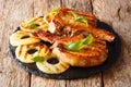 Main course: grilled pork chop steak in honey glaze with pineapples close-up on a slate plate. horizontal Royalty Free Stock Photo