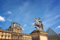 Main courtyard of the palace of the Louvre palace with an equestrian statue of king Louis XIV in Paris France Royalty Free Stock Photo