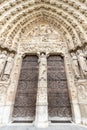 Main Entrance door of Notre Dame Cathedral in Paris. Ornate Facade with Sculptures and Statues, France