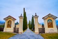 The main entrance and the alley with cypress trees of Sant\'Abbondio Chuch, Collina d\'Oro, Switzerland