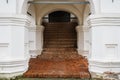 Main entrance in medieval estate with brick steps and white columns Royalty Free Stock Photo