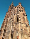 Main entrance of Roman Catholic Cathedral Notre Dame of Strasbourg in Alsace, France. Beautiful sunny day with clear blue sky Royalty Free Stock Photo