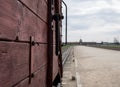 Main entrance to Auschwitz Birkenau Nazi Concentration Camp, showing one of the cattle cars used to bring victims to their death Royalty Free Stock Photo