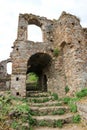 Main entrance to the ruin of medieval stone house with the stairway in abandoned byzantine city Mystras, Greece