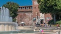 Main entrance to the Sforza Castle - Castello Sforzesco and fountain in front of it timelapse, Milan, Italy Royalty Free Stock Photo