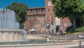 Main entrance to the Sforza Castle - Castello Sforzesco and fountain in front of it timelapse, Milan, Italy Royalty Free Stock Photo