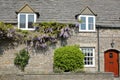 The main facade of a medieval house with brickstone and flagstone roof in Corfe Castle village, Isle of Purbeck, Dorset