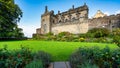 Main facade of medieval Stirling Castle with flower-filled gardens at the foot of the walls, Scotland.