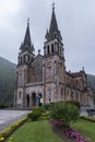 Main facade of the Sanctuary of the Virgin of Covadonga, Asturias, Spain, with its two tall bell towers and its characteristic