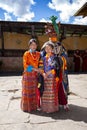 Bhutanese Cham masked dance, monk dress up for celebrate, with two girls , Tamshing Goemba, Nyingma, Bumthang, central Bhutan Royalty Free Stock Photo