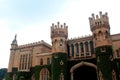 Main gate with battlement towers of bangalore palace with creeper plant.