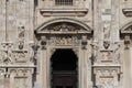 The main gate of Duomo milano, The entry door of Famous white Architectural cathedral church under blue sky at Milan Royalty Free Stock Photo