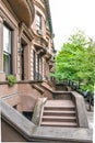 Main ladder and entry door. New york Harlem buildings. Brown houses. NYC, USA Royalty Free Stock Photo