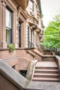 Main ladder and entry door. New york Harlem buildings. Brown houses. NYC, USA Royalty Free Stock Photo