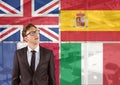 main language flags around young businessman thinking. office background Royalty Free Stock Photo